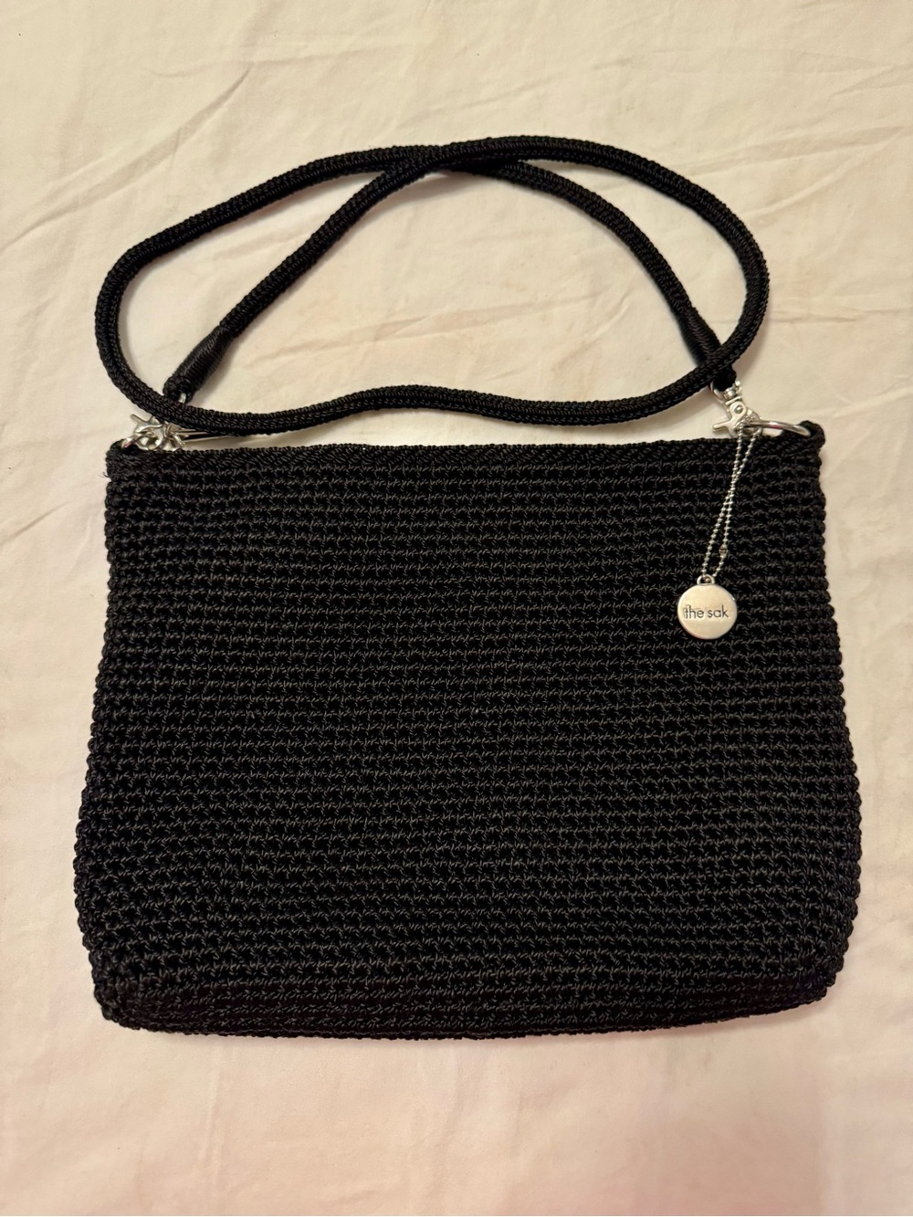 The Sak Black Woven Crossbody Bag with Branded Charm